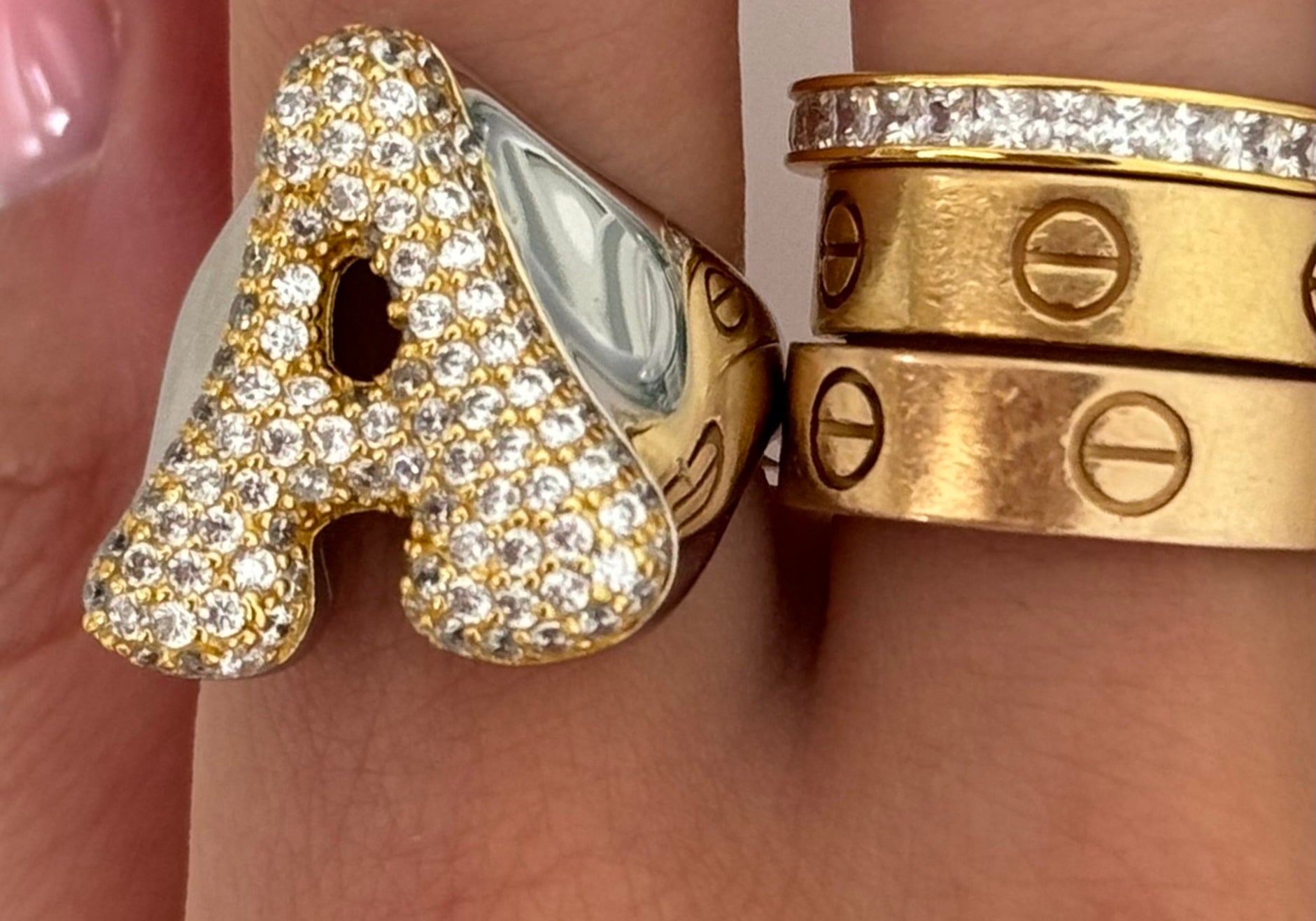 Iced Jumbo Letter Ring letter A stacked with gold bands on the finger