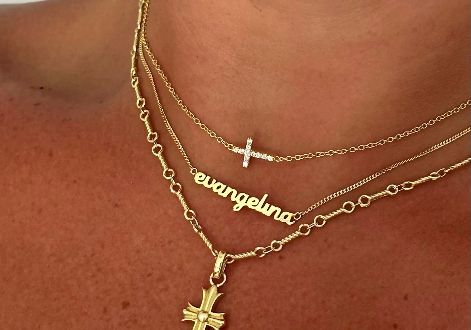 Baby Script Nameplate layered with gold cross necklaces