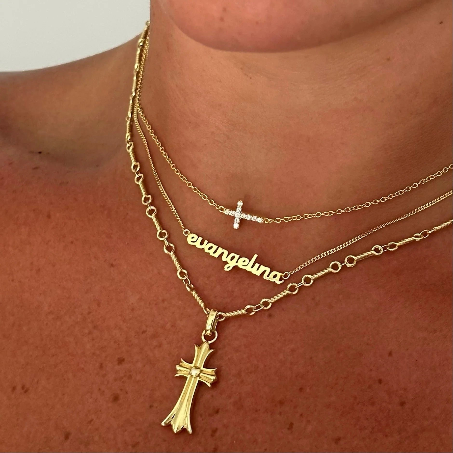 Baby Script Nameplate layered with gold cross necklaces