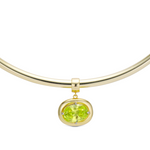 Birthstone Necklace with a light green birthstone pendant on a gold cuff necklace
