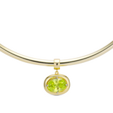 Birthstone Necklace with a light green birthstone pendant on a gold cuff necklace