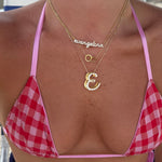CZ Baby Script Nameplate layered with an iced script letter necklace and gingham top