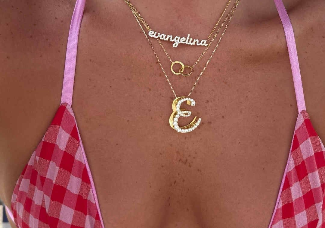 CZ Baby Script Nameplate layered with an iced script letter necklace and gingham top