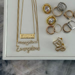 Gold script nameplate necklaces displayed with EP Jewels rings