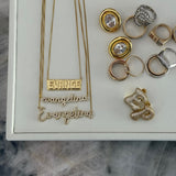Gold script nameplate necklaces displayed with EP Jewels rings