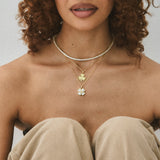 Model in a strapless top wearing the CZ Lucky 4 Me Necklace layered with a tennis necklace