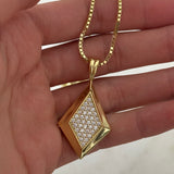 Hand holding the gold CZ Taylor Necklace on a box chain
