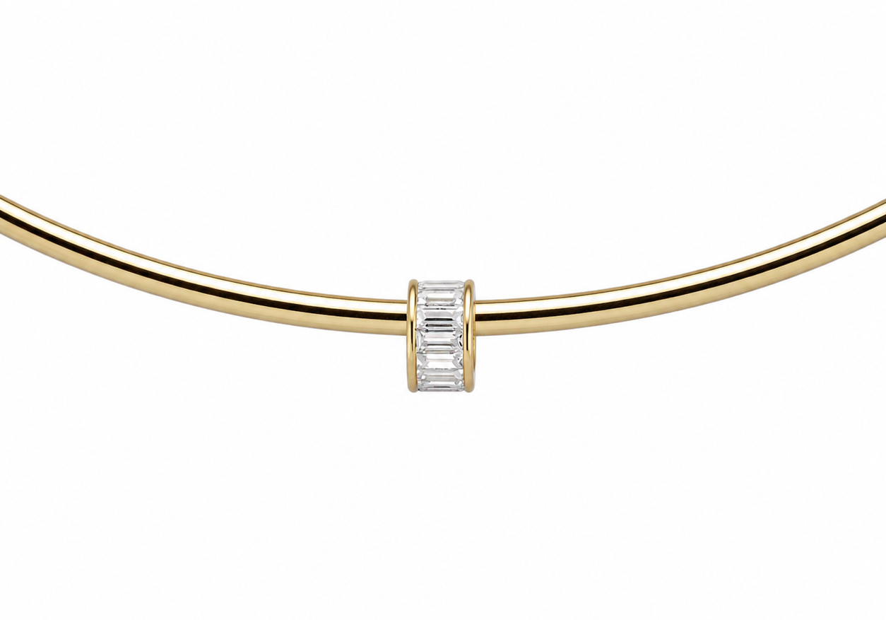 CZ Baguette Cuff Charm with clear April baguette stones on a gold cuff