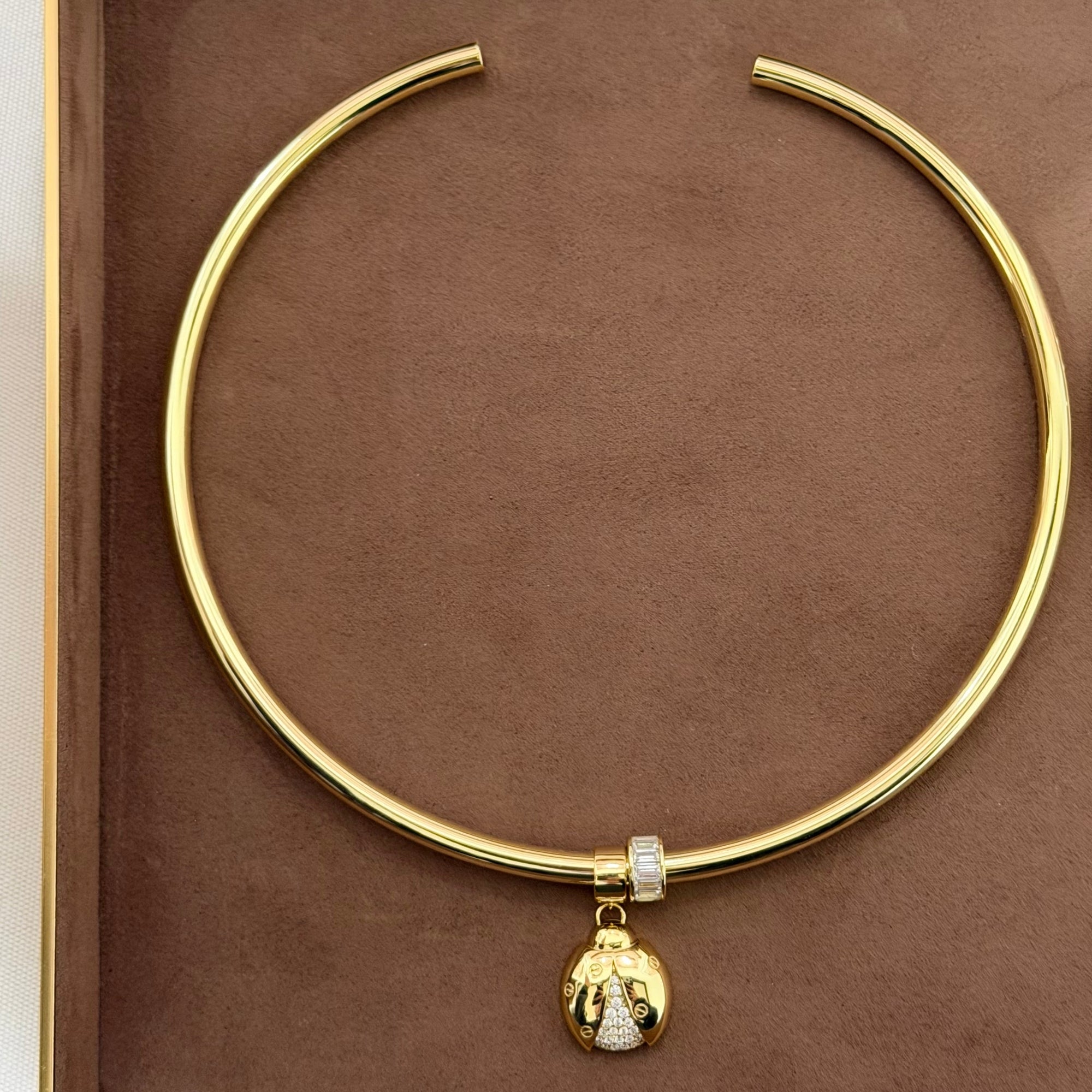Classic gold cuff necklace with a CZ slider charm and gold pendant charm