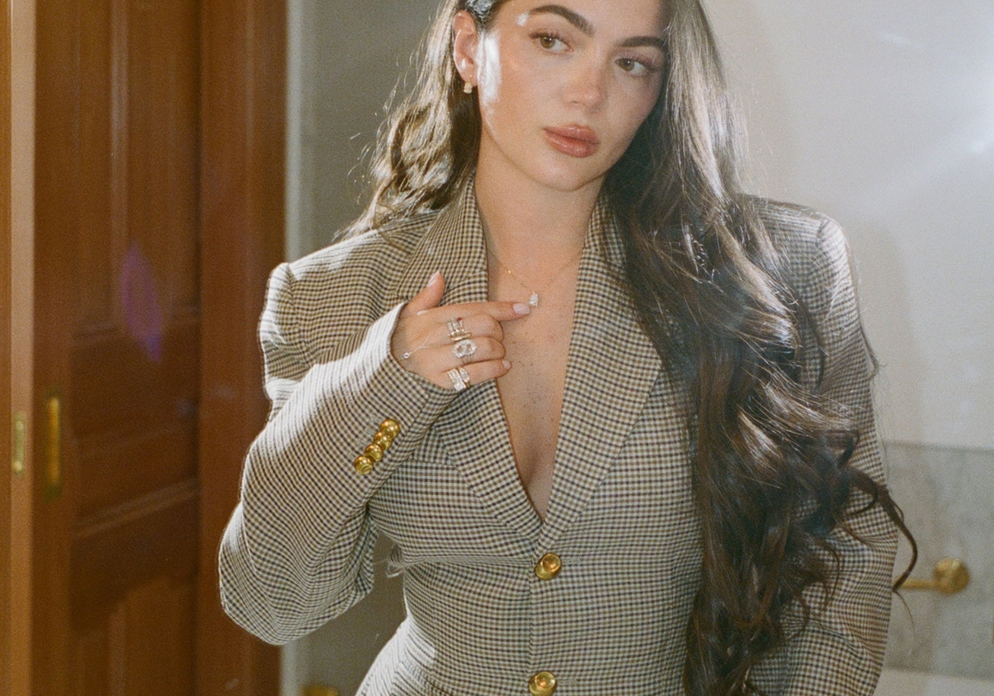 Model in a houndstooth blazer wearing the Classic Pear Diamond Necklace in 14K solid gold