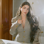 Model in a houndstooth blazer wearing the Classic Pear Diamond Necklace in 14K solid gold