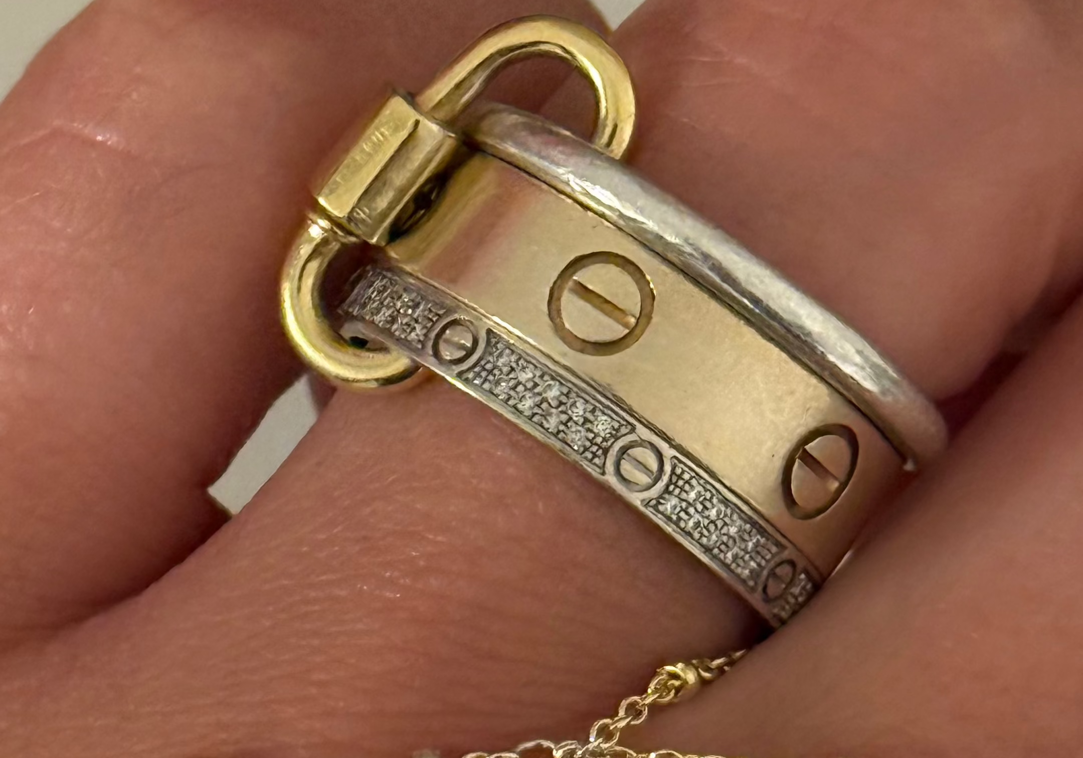 Classic Ring Link Carabiner holding a stack of gold and silver rings on the finger