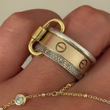 Classic Ring Link Carabiner holding a stack of gold and silver rings on the finger