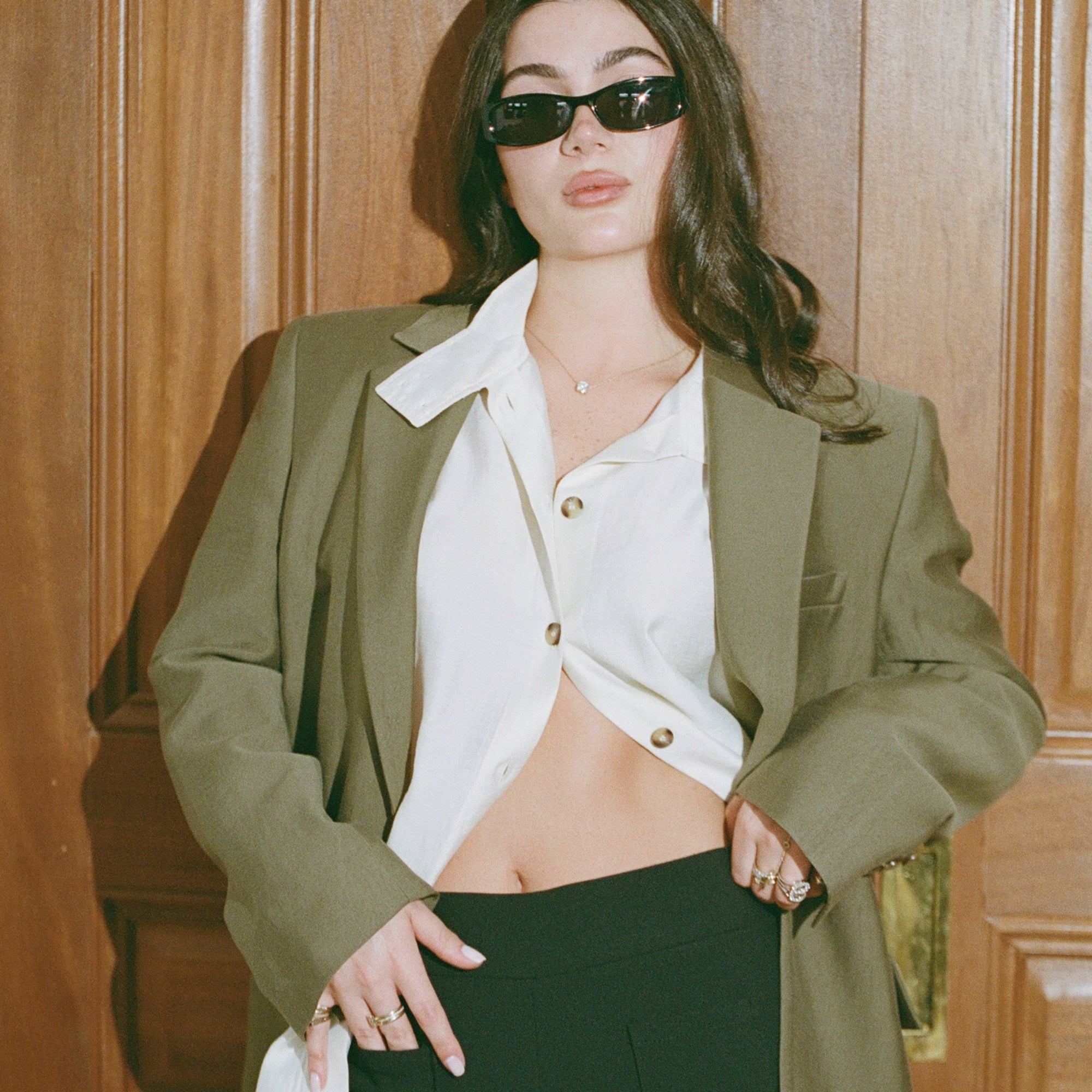 Model in an olive blazer and white shirt wearing the Classic Round Diamond Necklace