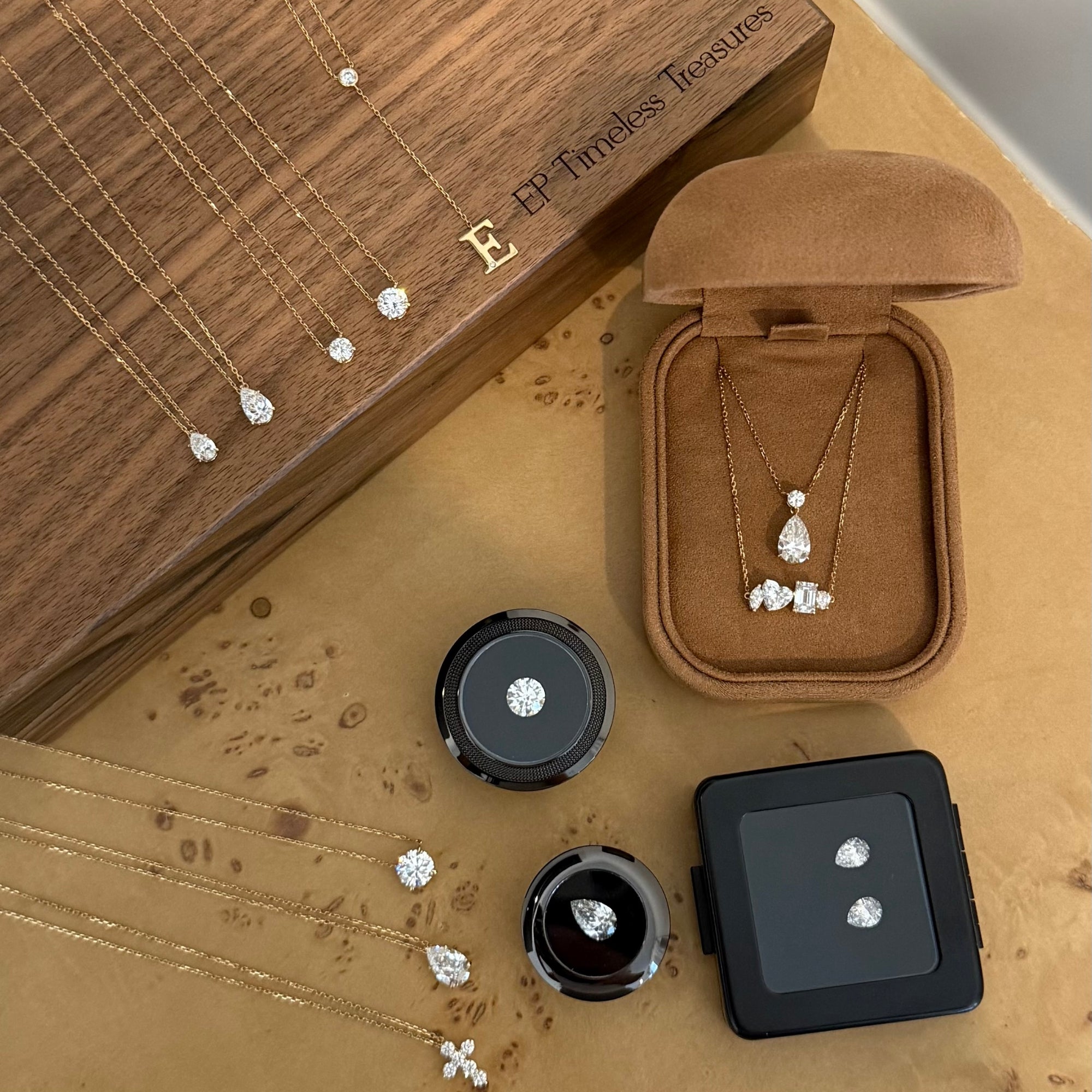 Loose lab diamonds and EP Timeless 14K solid gold necklaces in a tan velvet box
