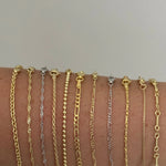 Close-up of gold and silver Dainty Chain styles side by side