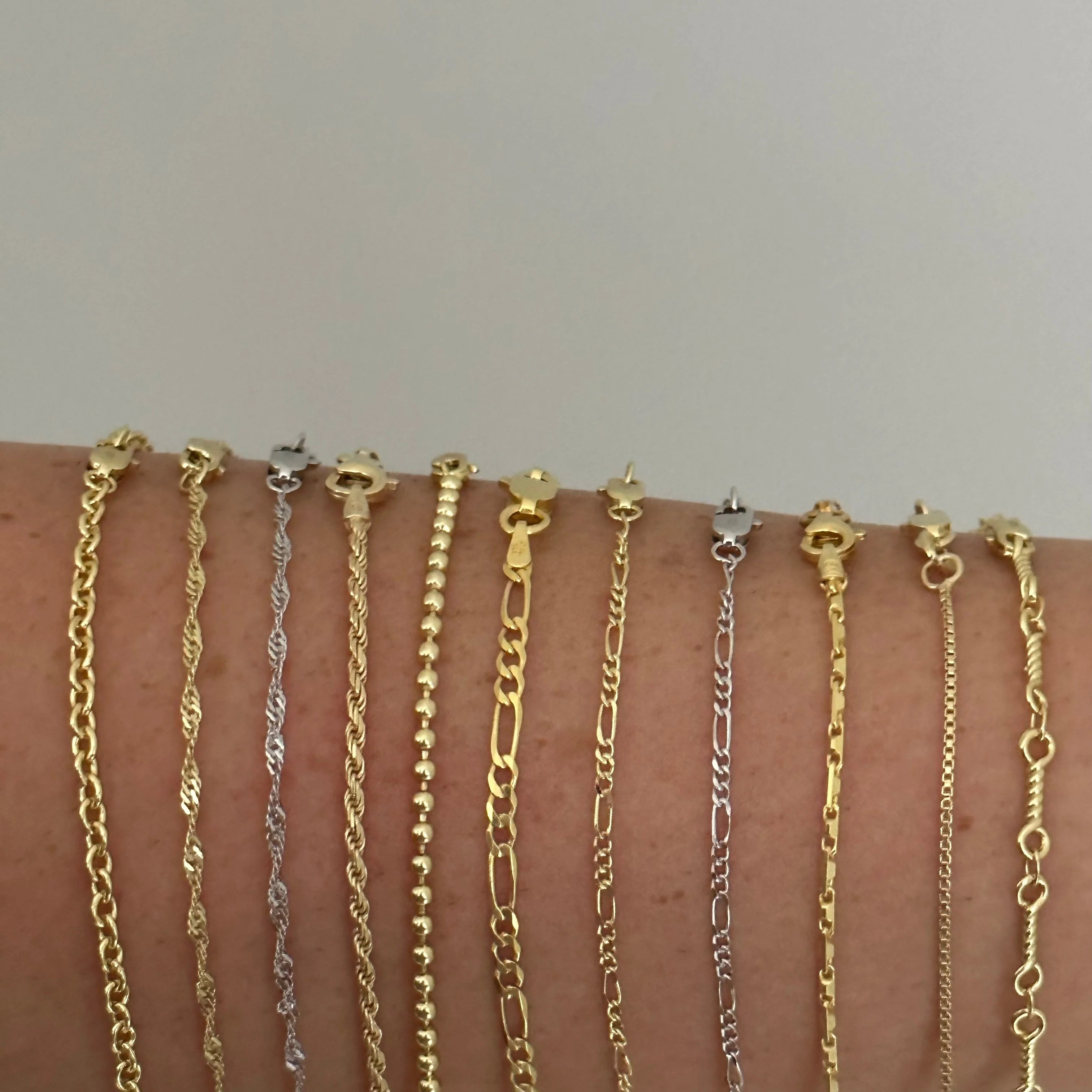 Close-up of gold and silver Dainty Chain styles side by side