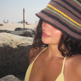 Woman in a bucket hat wearing the gold Double Amore Necklace