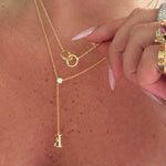 Double Amore Necklace layered with a lariat letter necklace, close-up