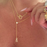 Double Amore Necklace layered with a lariat letter necklace, close-up
