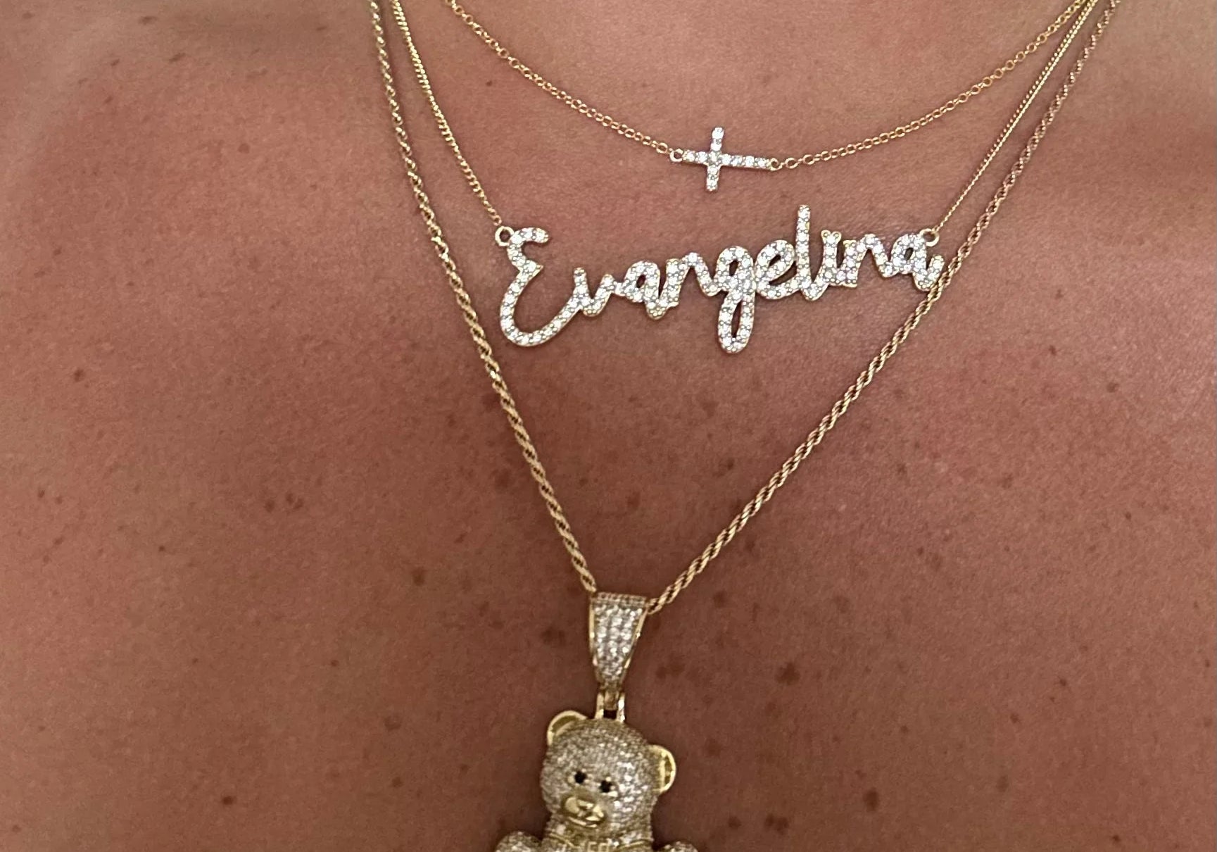 Dreamy Script Nameplate in Evangelina layered with a cross and teddy necklace