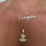 Dreamy Script Nameplate in Evangelina layered with a cross and teddy necklace