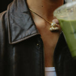 Model in a leather jacket with a matcha wearing the Iced Jumbo EP Teddy Necklace