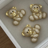 Three gold Iced Jumbo EP Teddy pendants in a jewelry tray