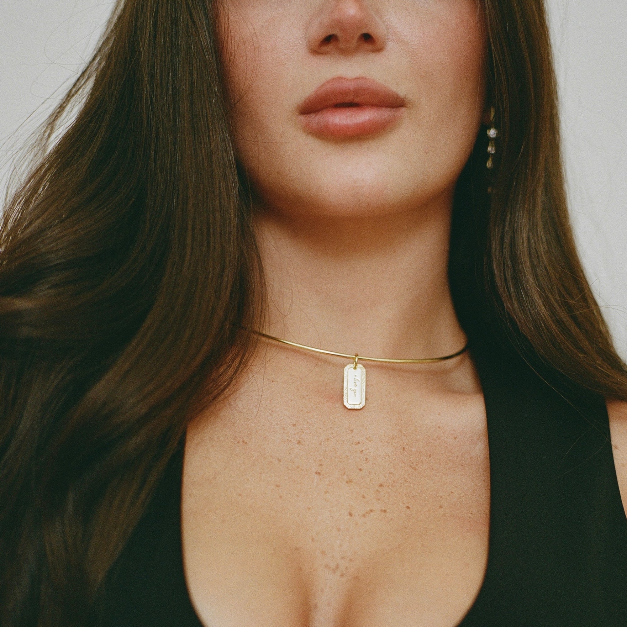 Model wearing the Engraved Tag Nameplate on a cuff