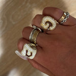 Hand stacked with Iced Jumbo Letter Rings in G and C with gold bands