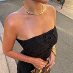 Model in a strapless black top wearing the gold Classic Cuff Necklace