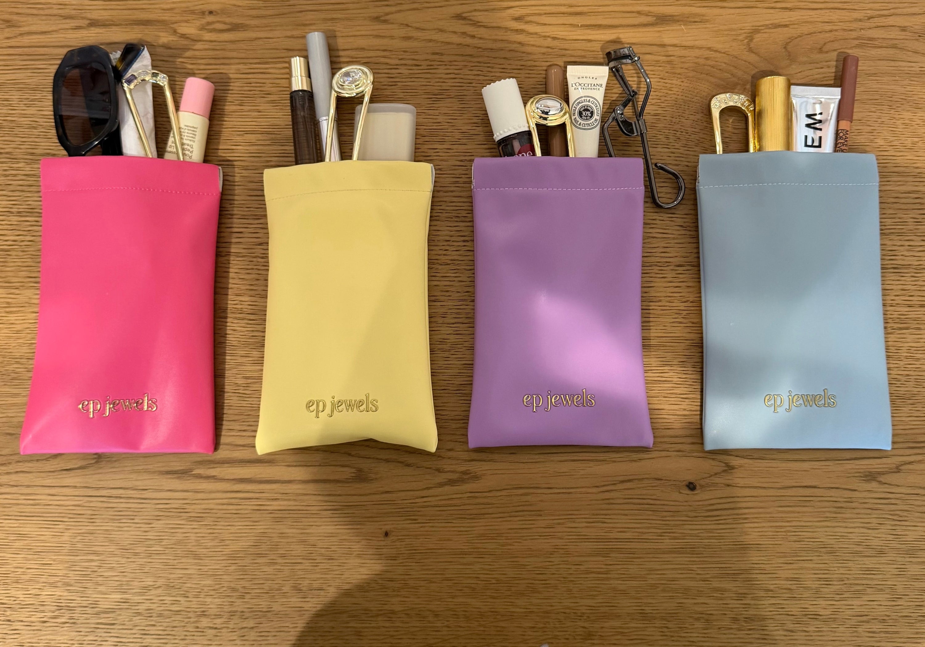 EP Jewels hair pin pouches in hot pink, butter yellow, lavender and baby blue holding hair pins