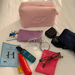 EP Jewels lavender and hot pink hair pin pouches packed in a travel bag