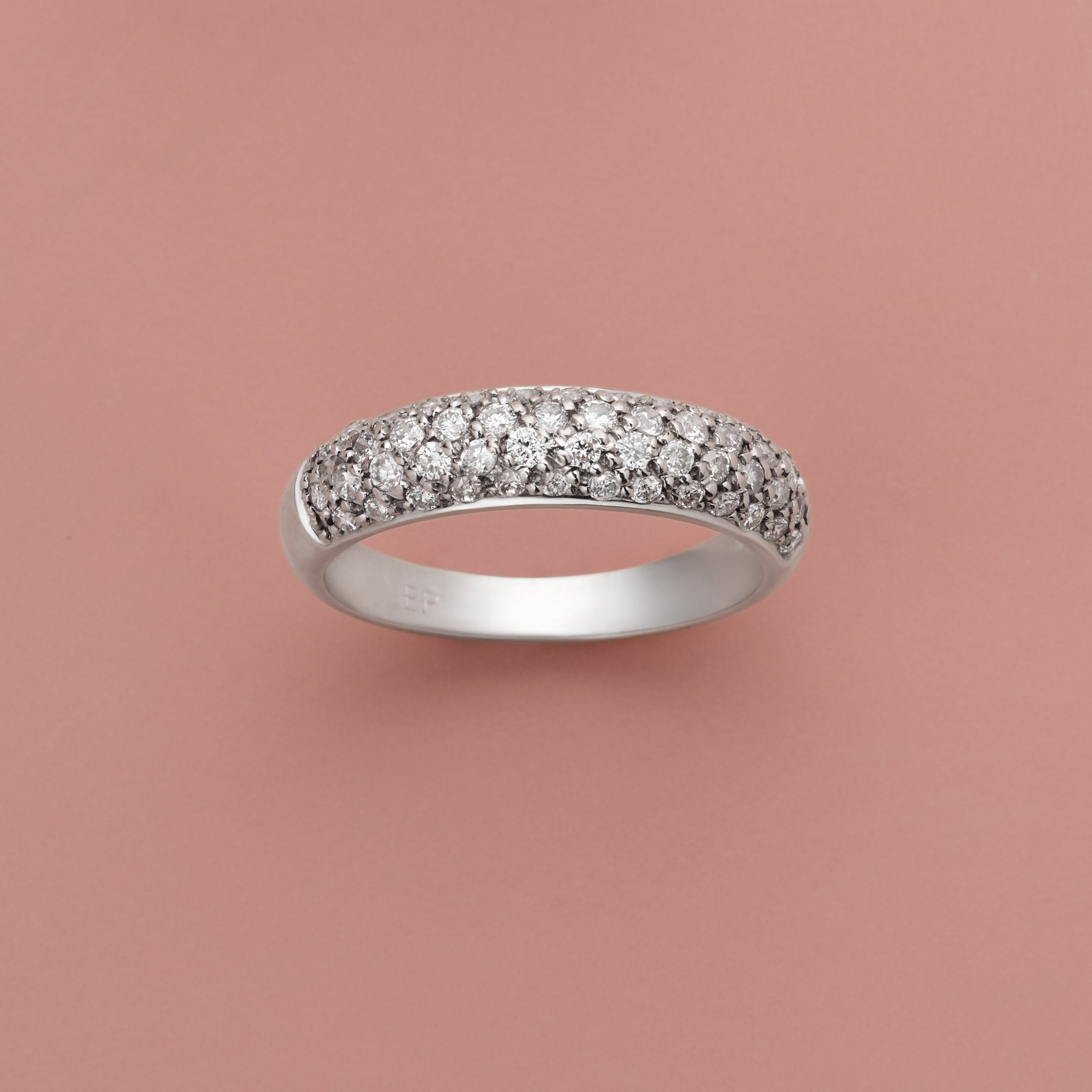 Half Diamond Pave Band in 14K white gold with lab-grown diamonds on a pink background