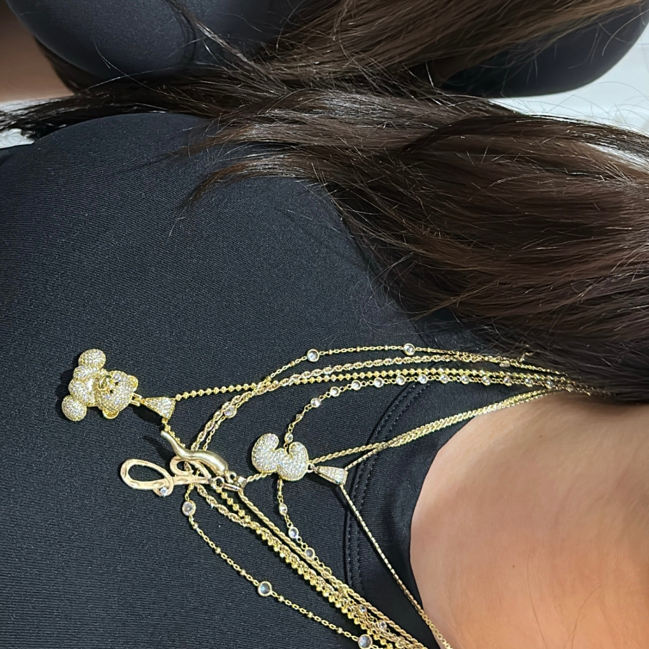 Gold Iced EP Teddy Necklaces draped over a shoulder
