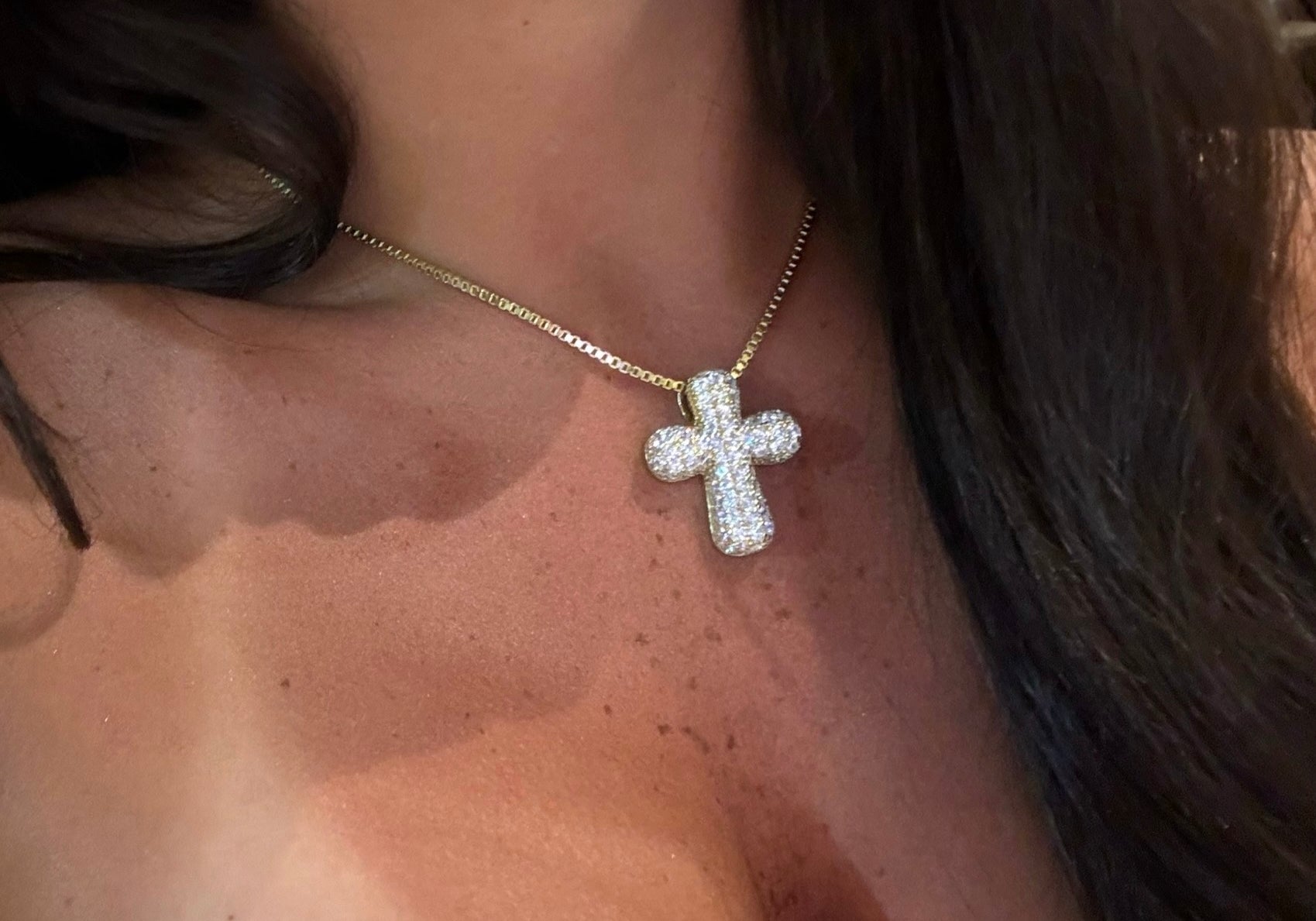Model wearing the Iced Jumbo Cross Necklace with a strapless top