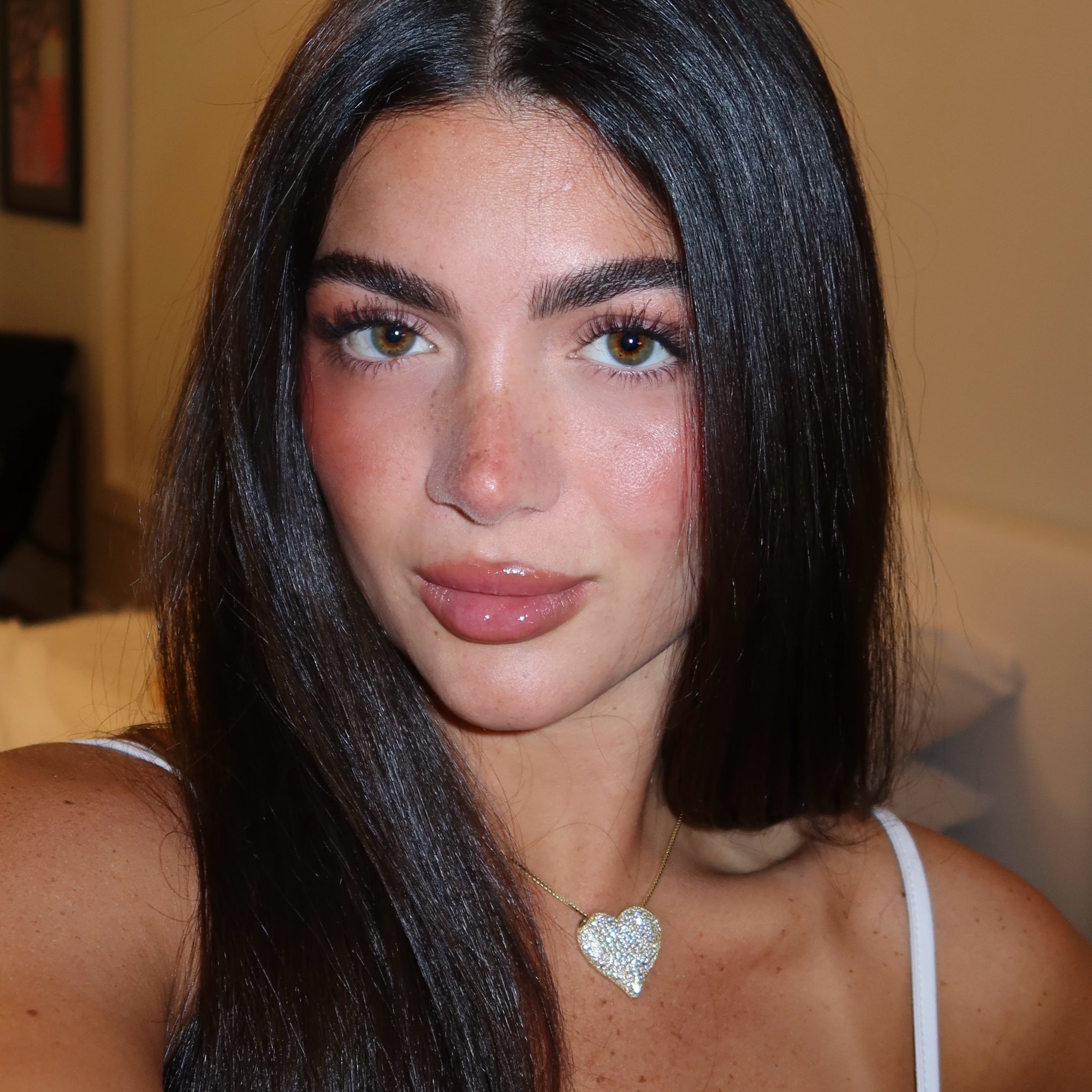 Close-up portrait of a model wearing the gold Iced Jumbo Heart Necklace