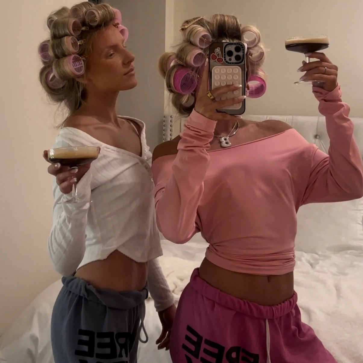 Two friends wearing iced jumbo letter necklaces