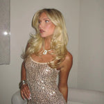Model wearing a gold iced jumbo letter necklace with a sequin dress