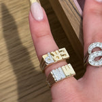 Close-up of a solid 14K gold Initial Pinky Ring with lab-grown diamonds on the pinky