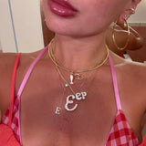 Gold lariat letter necklace layered with iced jumbo letter necklaces