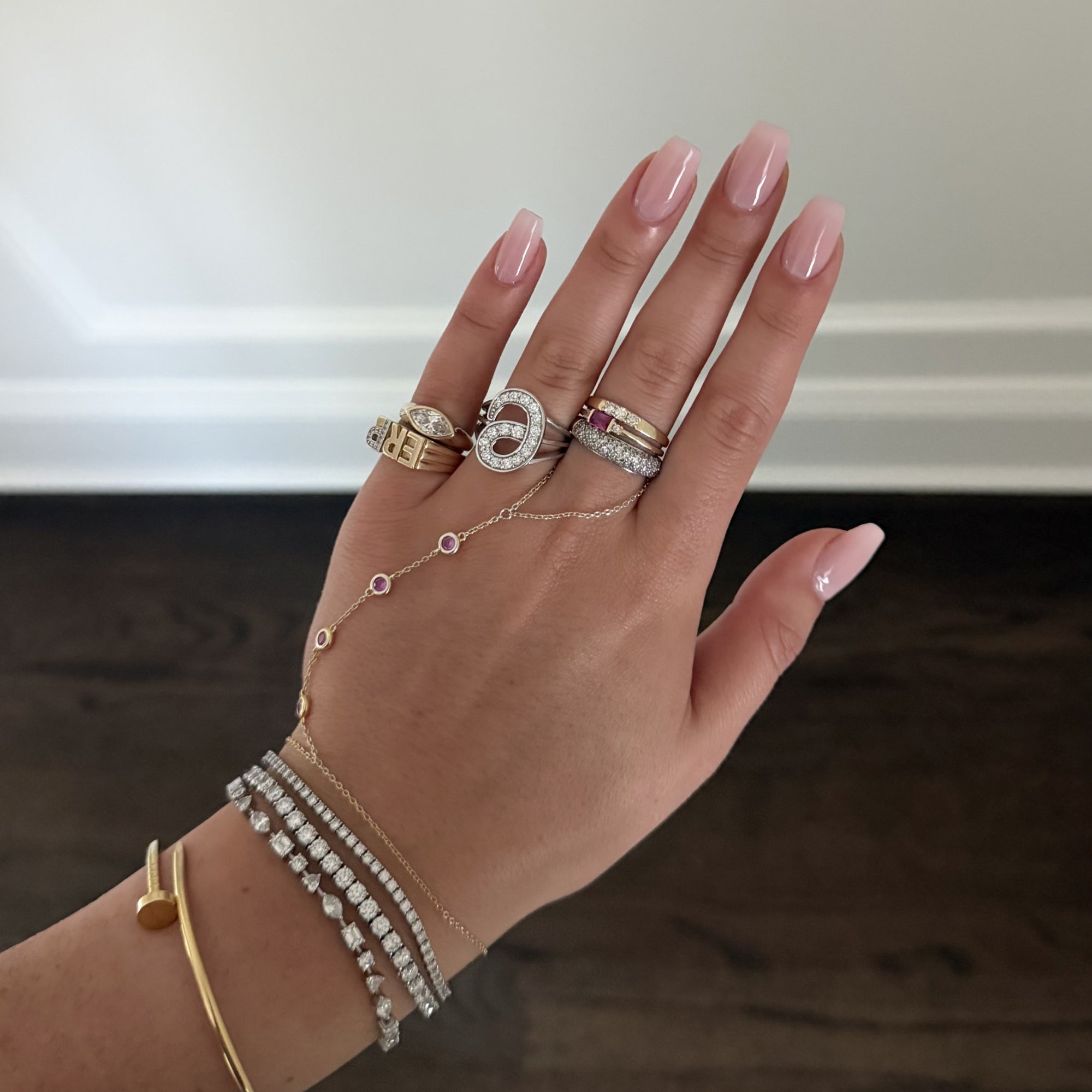 Hand stacked with EP Timeless 14K solid gold rings, with a gold hand chain and diamond tennis bracelets