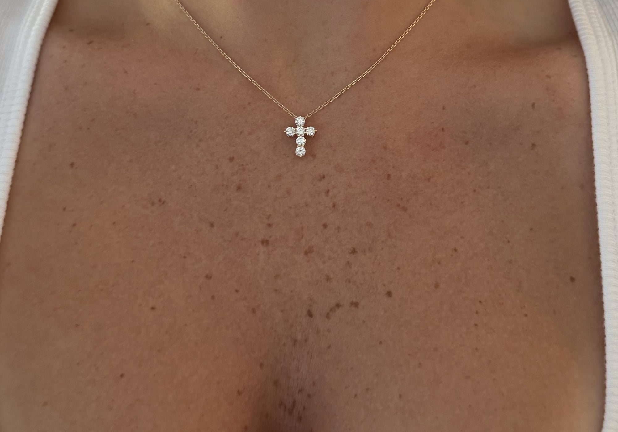 Mini Diamond Cross Necklace worn on the neckline, 14K solid gold fine jewelry