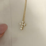 Mini Diamond Cross Necklace held up to show the lab-grown diamond cross in 14K solid gold