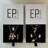 Mother Mary Rosary Necklace in an EP Jewels gift box beside other gold necklaces