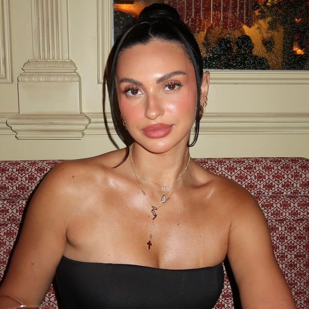 Model in a strapless black top wearing the Mother Mary Rosary Necklace