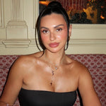 Model in a strapless black top wearing the Mother Mary Rosary Necklace
