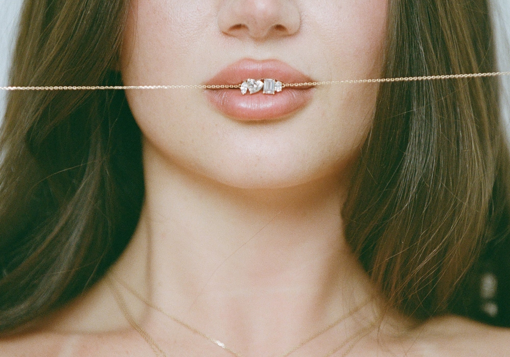 Model holding the Multi Shape Diamond Necklace chain in her teeth, 14K solid gold