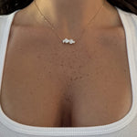Multi Shape Diamond Necklace worn on the collarbone with a white top