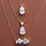 Multi Shape, Pear Dangle and Classic Pear Diamond Necklaces layered on brown, 14K solid gold